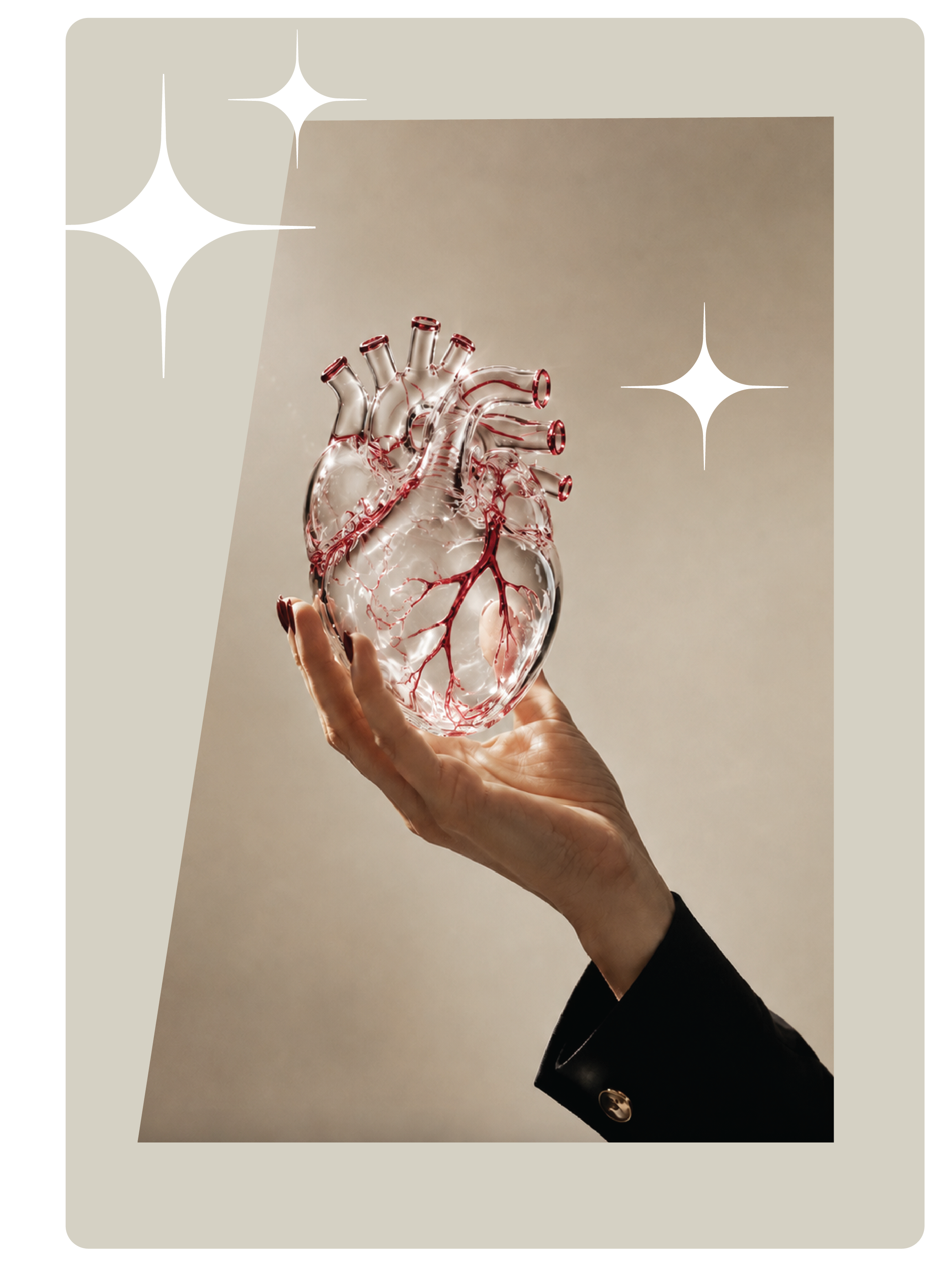A hand holding a glass anatomical heart